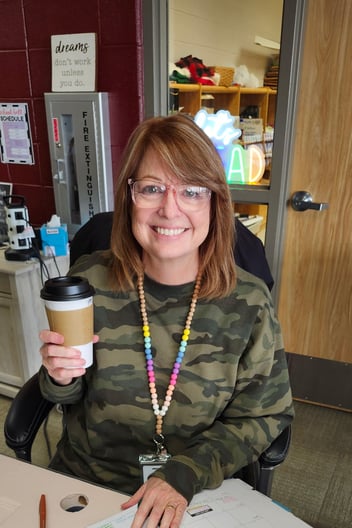 A woman holds a coffee