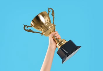 Hand holding a trophy