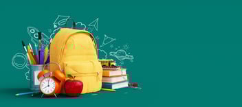 Yellow backpack surrounded by school supplies