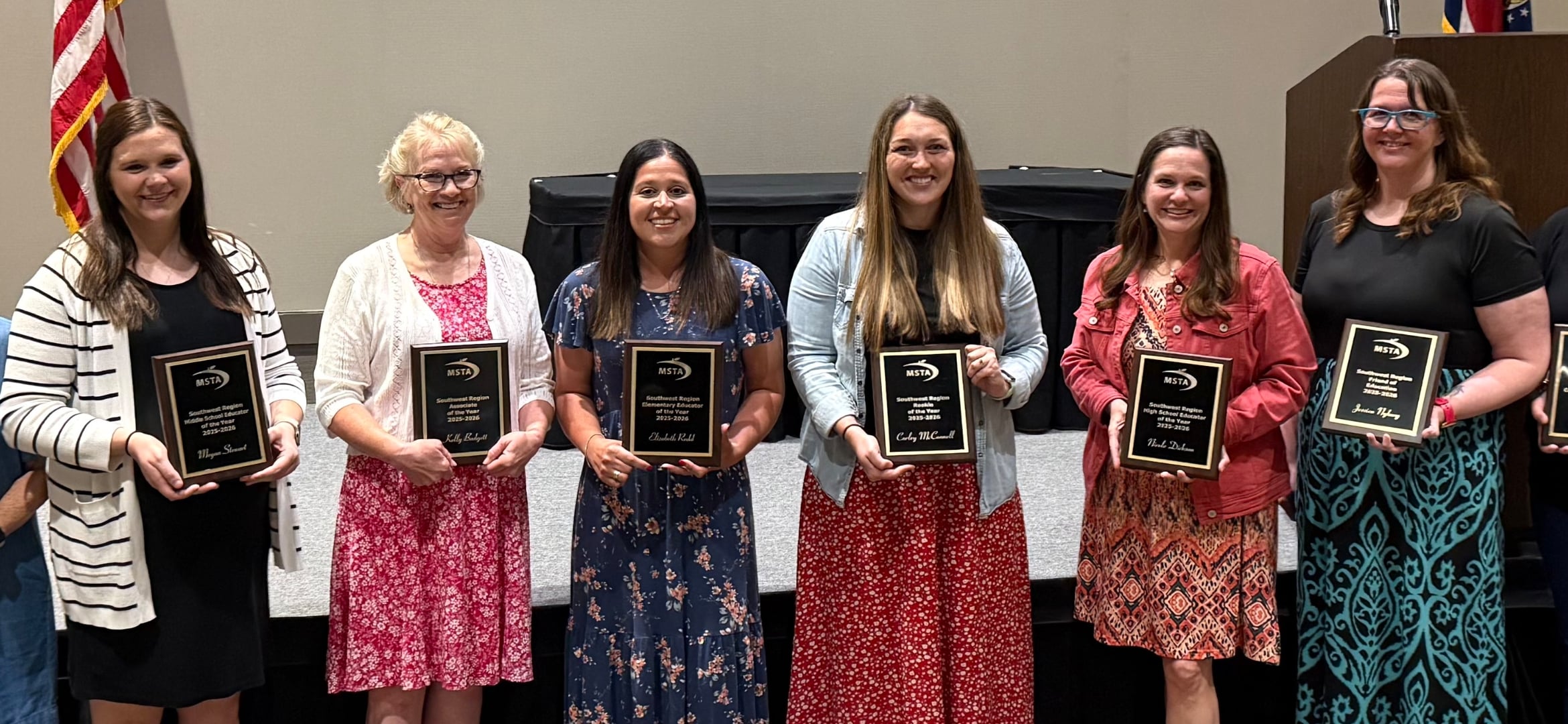 Women holding plaques