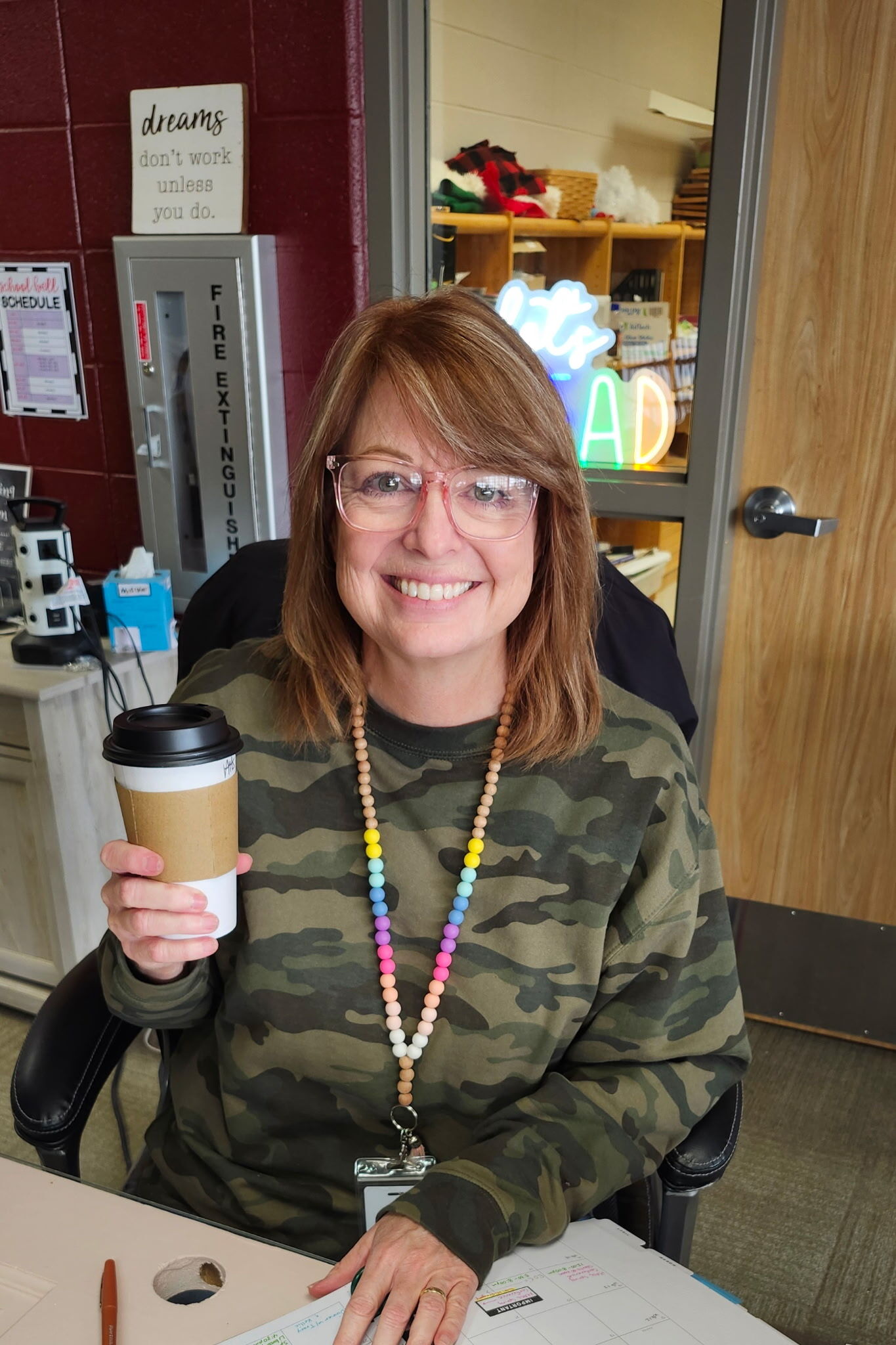 A woman holds a coffee