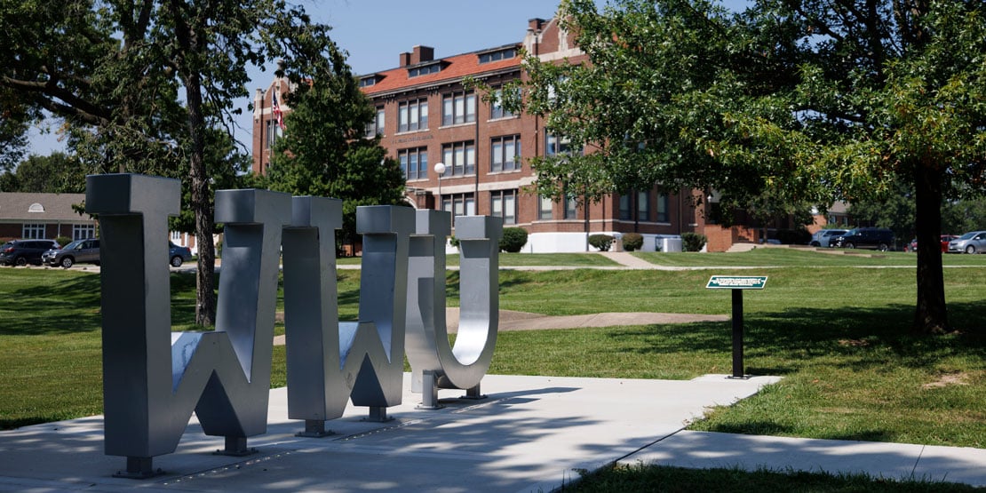 "WWU" statue on a green lawn