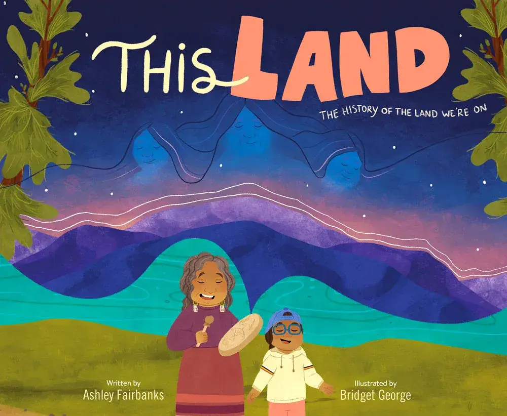 A book cover with the text "This Land, the history of the land we're on" with two cartoon women standing in front of a naturescape
